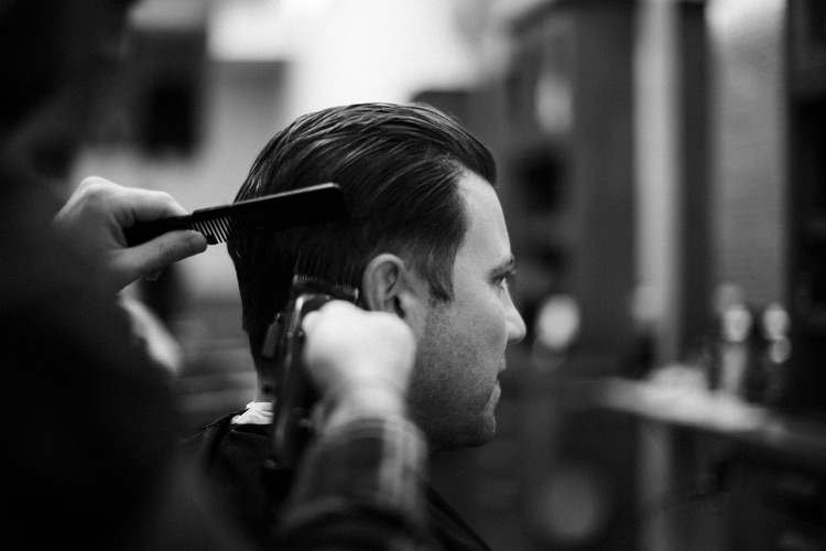 Handlebar Salon master barber giving a precision haircut in Stamford, CT